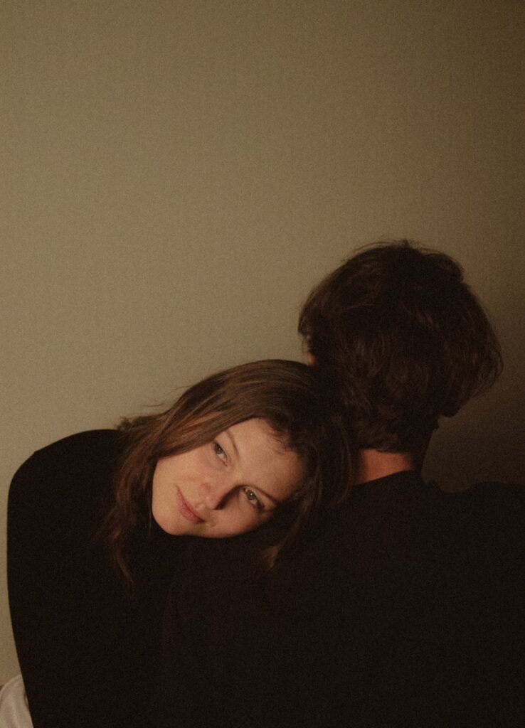 Woman resting head on man's shoulder